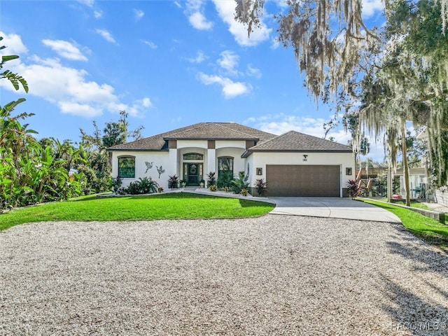 view of front facade with a front yard and a garage