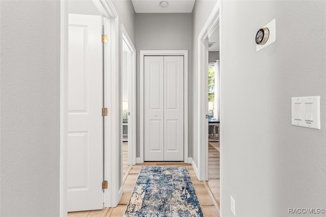 hallway with light wood-type flooring