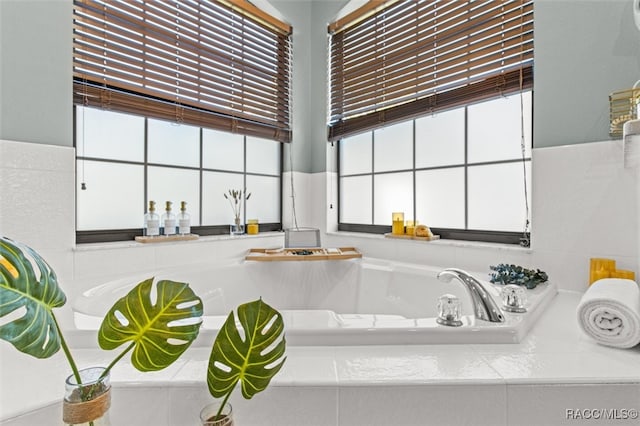 interior space with a healthy amount of sunlight and tiled bath