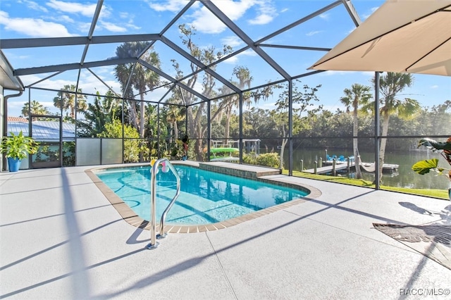 view of pool with a lanai, a water view, and a patio