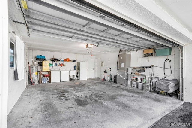 garage featuring water heater, separate washer and dryer, a garage door opener, and sink