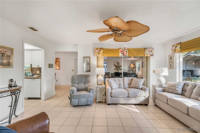 tiled living room featuring ceiling fan