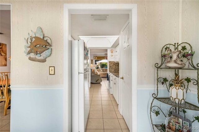 corridor with light tile patterned floors