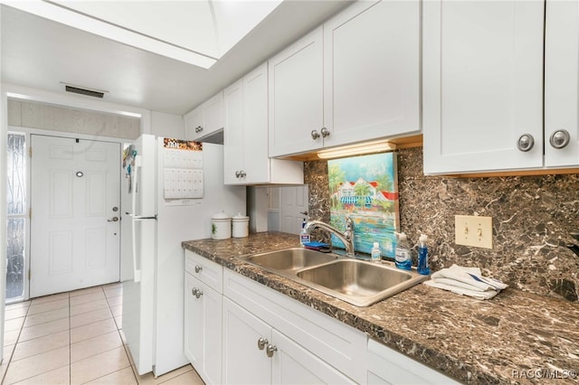 kitchen with decorative backsplash, sink, and white cabinetry