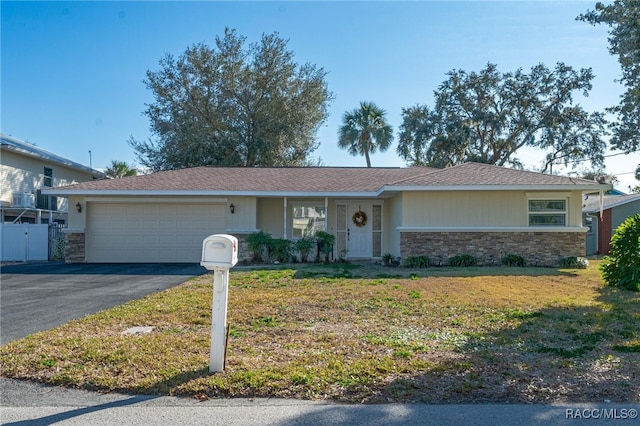 ranch-style home with a garage and a front lawn