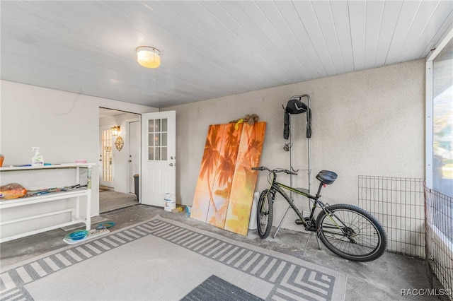 miscellaneous room featuring concrete flooring and wood ceiling