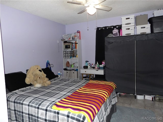 bedroom with a textured ceiling and ceiling fan