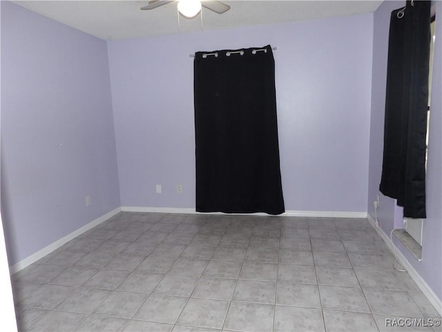 spare room with light tile patterned floors and ceiling fan