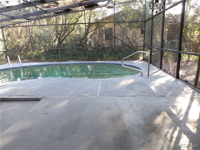 view of pool with a lanai and a patio area