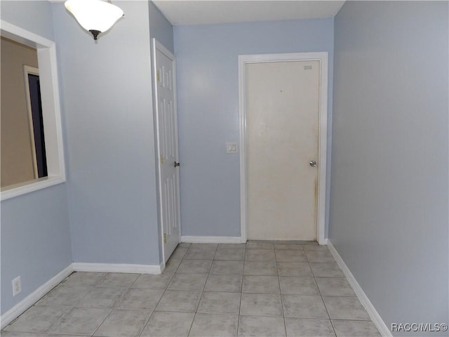 hall with light tile patterned flooring