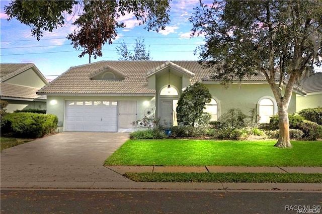 view of front facade with a front yard and a garage