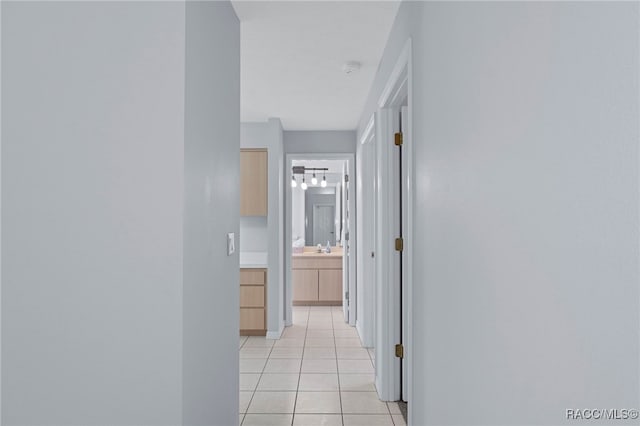 hall with light tile patterned floors