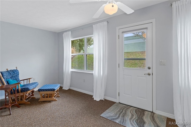 entryway with carpet and ceiling fan