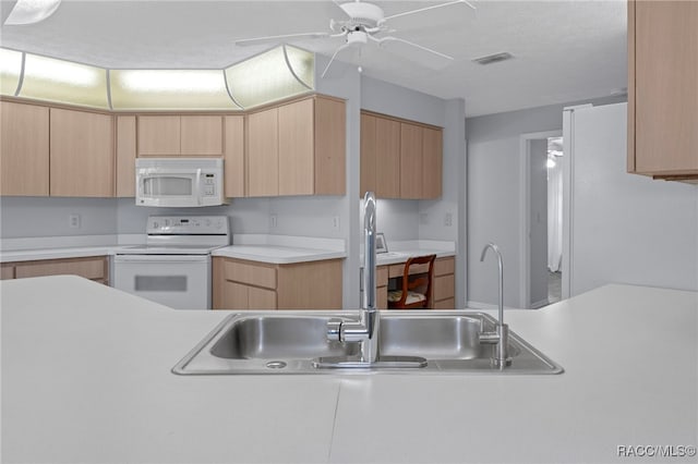 kitchen featuring light brown cabinets and white appliances