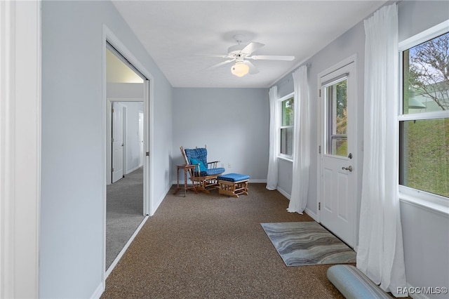 sitting room with ceiling fan, a healthy amount of sunlight, and carpet floors