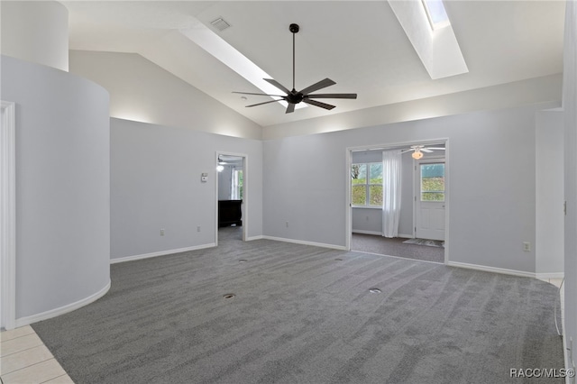 interior space featuring a skylight, high vaulted ceiling, and ceiling fan