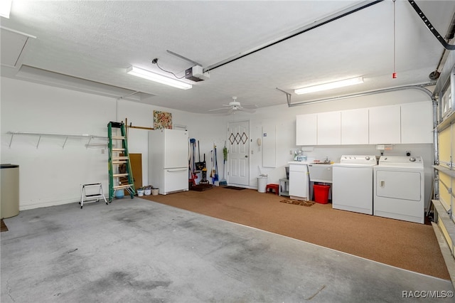 garage with washer and dryer, white refrigerator, a garage door opener, and ceiling fan