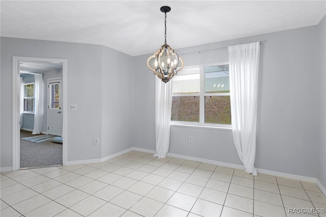 spare room featuring a chandelier