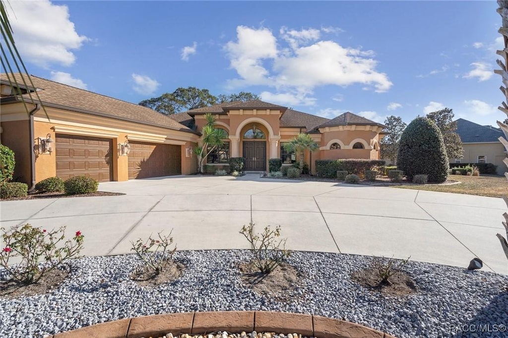 mediterranean / spanish house featuring a garage