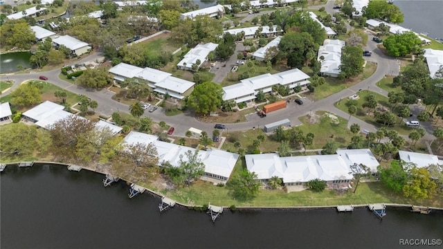 drone / aerial view with a residential view and a water view