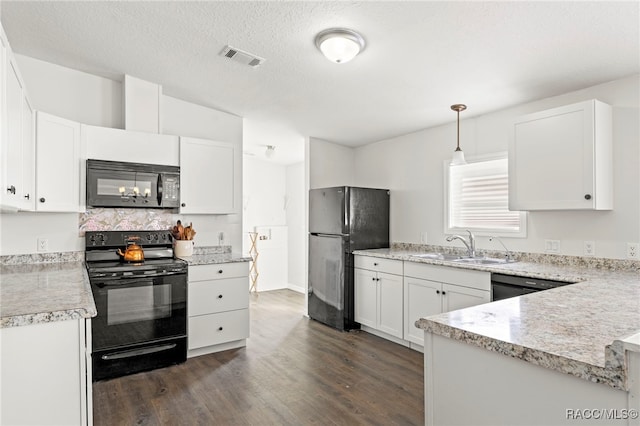 7187 Montier St, Weeki Wachee, FL 34613 - kitchen featuring black appliances, a sink, dark wood-style floors, light countertops, and white cabinets