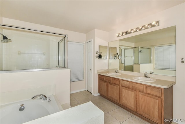 bathroom with plus walk in shower, tile patterned flooring, and vanity