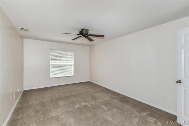 carpeted empty room featuring ceiling fan