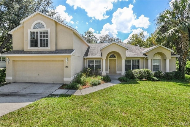 view of front facade with a front lawn and a garage