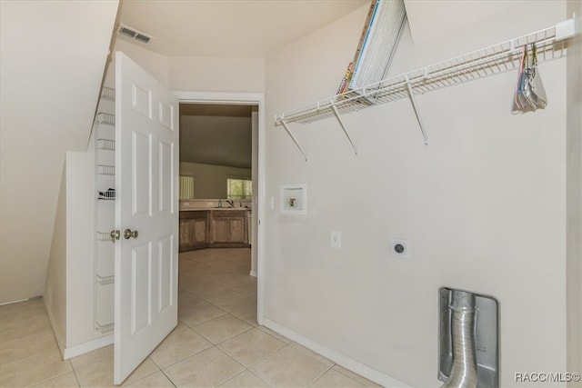 laundry room featuring light tile patterned floors, washer hookup, and hookup for an electric dryer