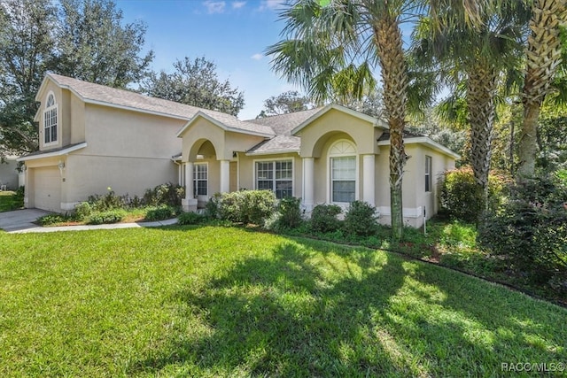 ranch-style home featuring a garage and a front lawn