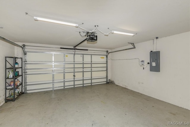 garage with a garage door opener and electric panel