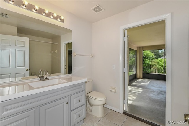 bathroom with tile patterned floors, vanity, and toilet