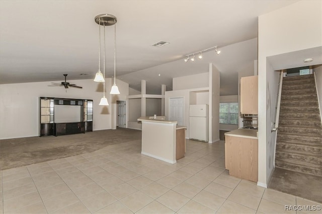 kitchen featuring ceiling fan, high vaulted ceiling, white fridge, hanging light fixtures, and light tile patterned flooring