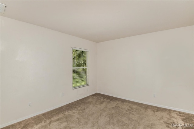 unfurnished room with light colored carpet