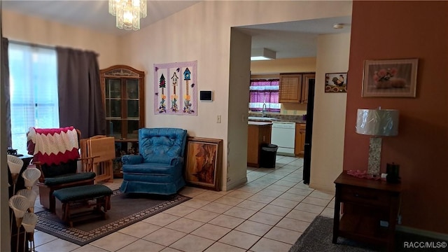 living area featuring light tile patterned floors, sink, and an inviting chandelier