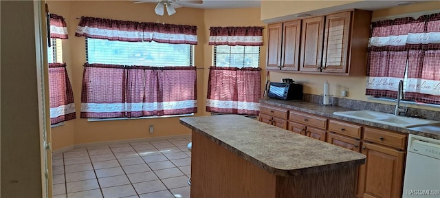 kitchen with white dishwasher, sink, ceiling fan, and light tile patterned flooring