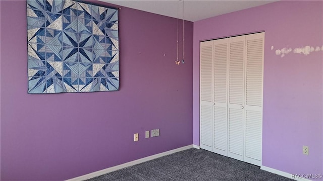 unfurnished bedroom featuring a closet and carpet flooring