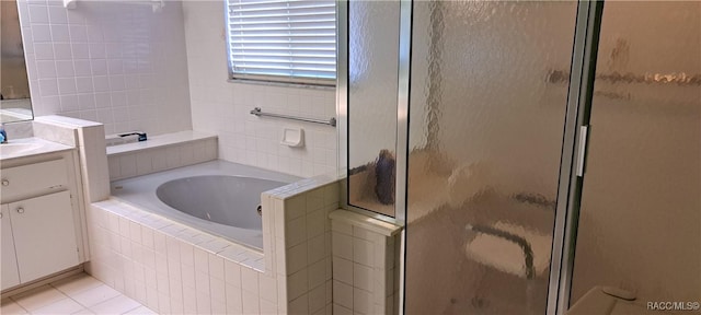 bathroom featuring tile patterned floors, vanity, and plus walk in shower