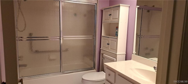 full bathroom with toilet, bath / shower combo with glass door, and vanity