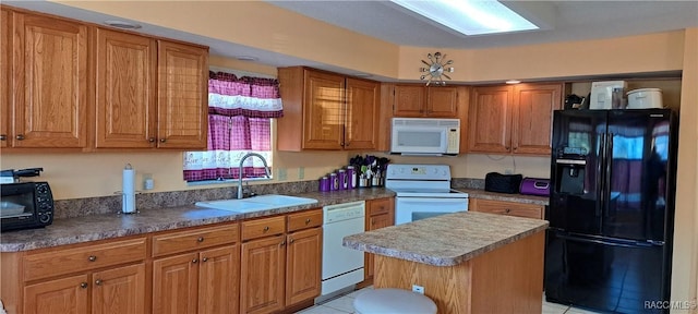 kitchen featuring sink, white appliances, light tile patterned floors, and a kitchen island