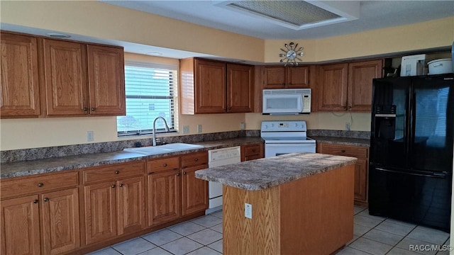 kitchen featuring light tile patterned floors, brown cabinetry, a kitchen island, a sink, and white appliances