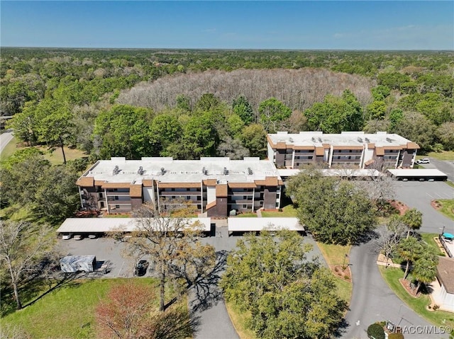 birds eye view of property featuring a wooded view