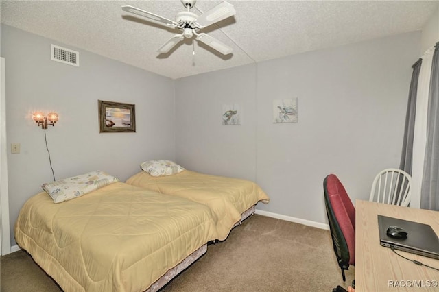 carpeted bedroom with a textured ceiling, ceiling fan, visible vents, and baseboards