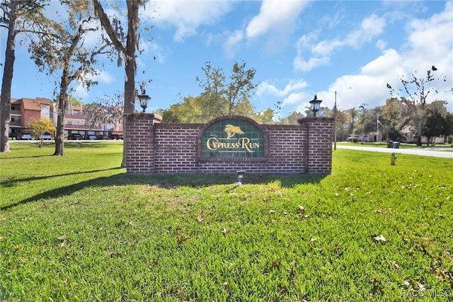 community / neighborhood sign with a lawn