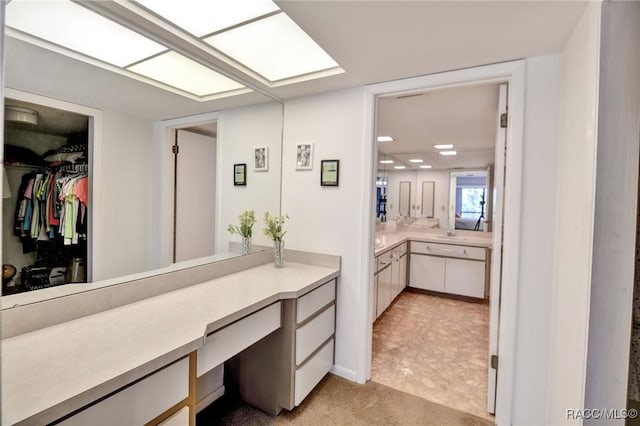 bathroom with a skylight and vanity