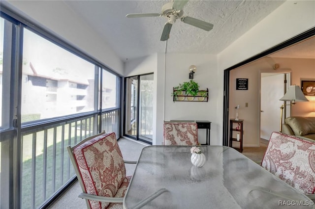 sunroom / solarium featuring a ceiling fan