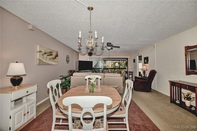 carpeted dining space with a notable chandelier, baseboards, and a textured ceiling