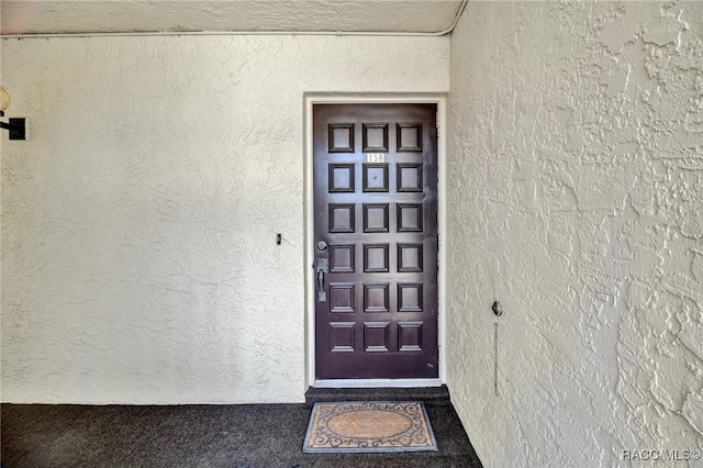 doorway to property with stucco siding