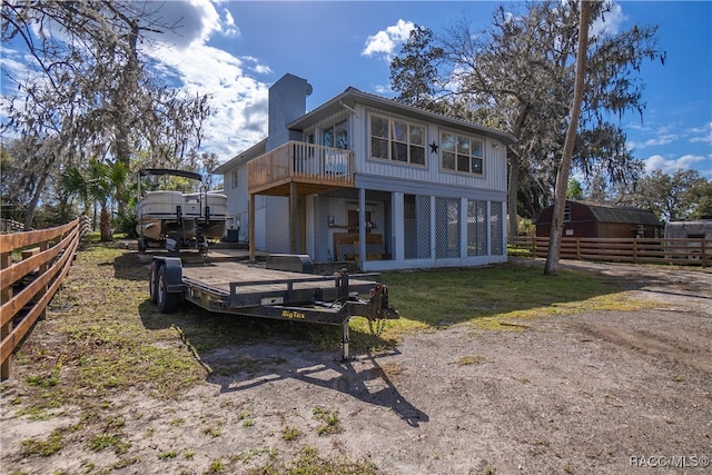 back of house featuring a wooden deck