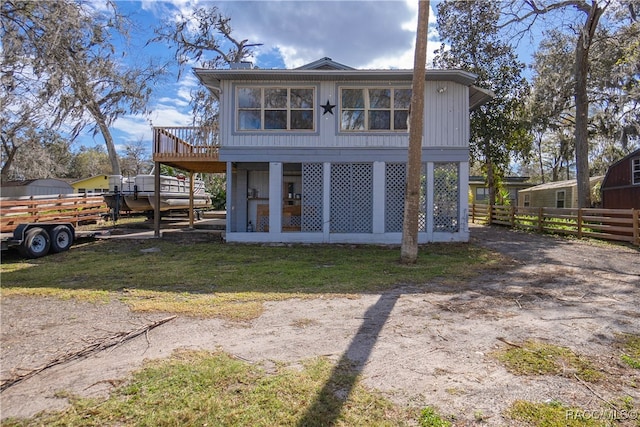 back of house featuring a wooden deck